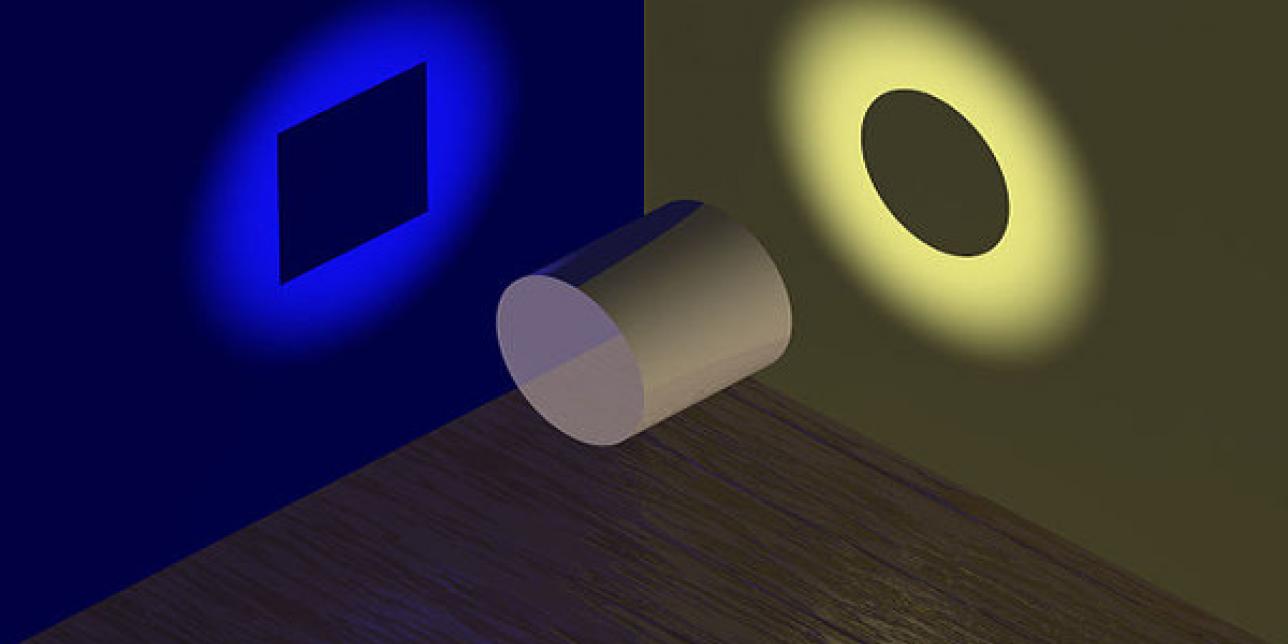 Imagen que muestra un cilindro y se proyectan sus sombras en dos superficies, en una se ve la sombra de un círculo y en la otra se ve la sombra de un rectángulo.